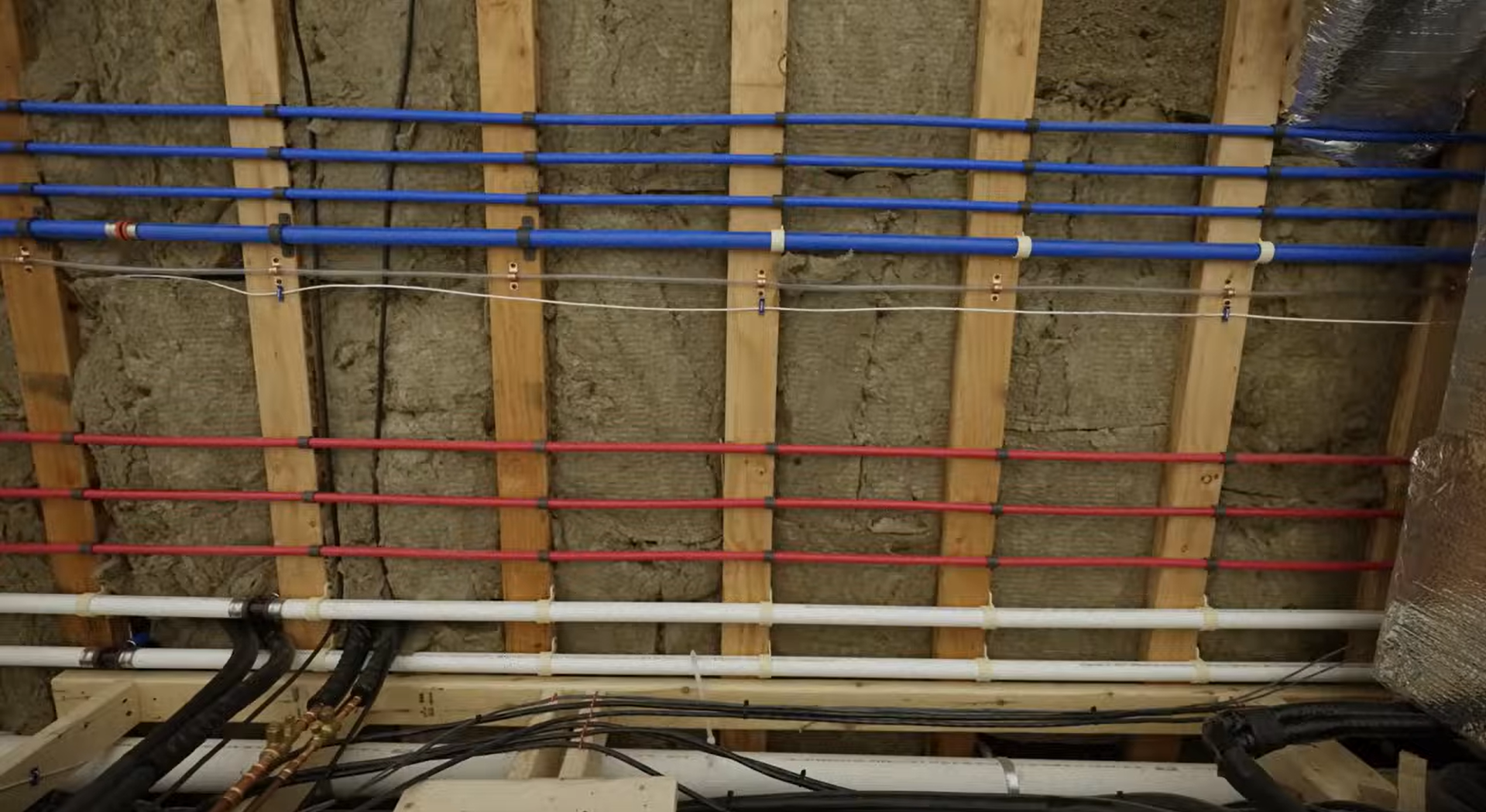 PEX water lines run to a manifold with clean hot and cold routing
