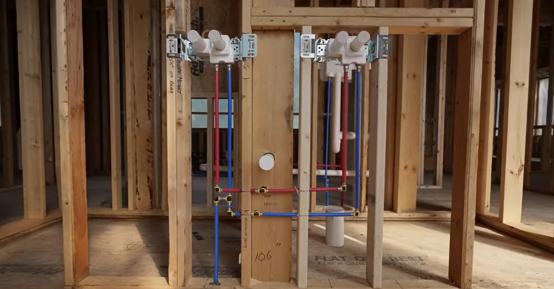 Bathroom rough-in with mixing valves and supply lines set in the framing
